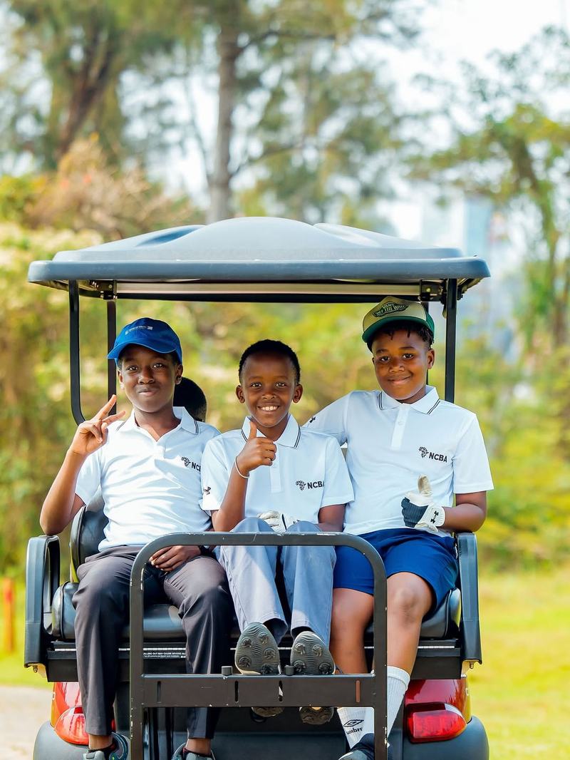 Junior golfers on golf cart at Kigali Golf Resort